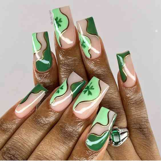 St Patrick nail designs with clover leaves and swirls in gold and 2 green shades