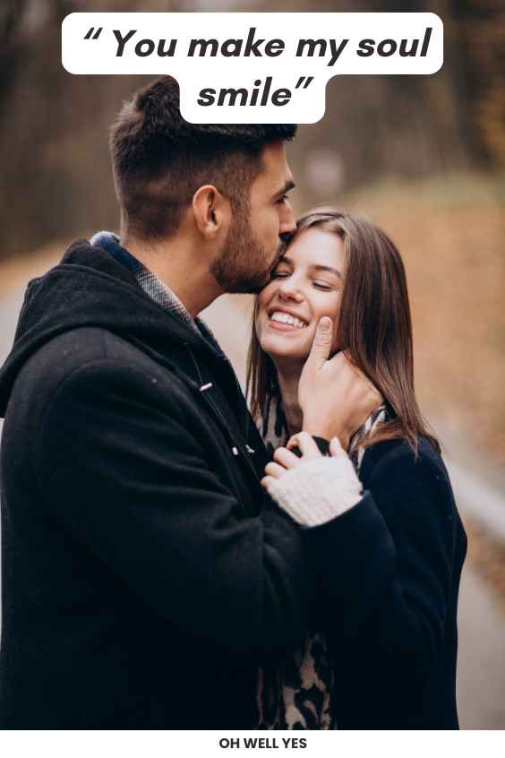 woman smiling man kissing her forehead