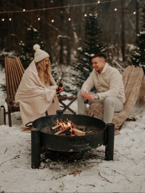 Couple enjoying New Year's Eve near a firepit