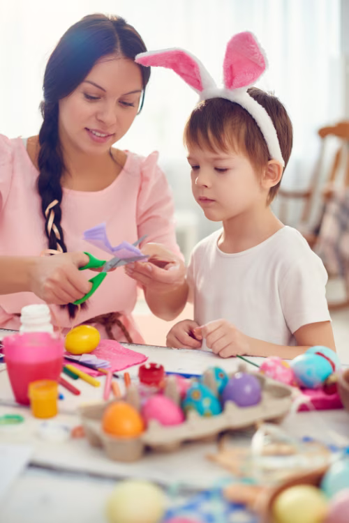 a mother and son decorating Easter eggs as part of Easter tradition